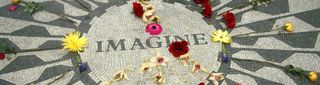 Tile mosaic with the word imagine and flowers.