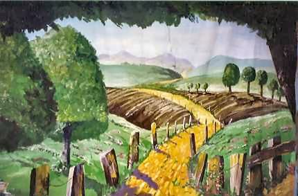 Painting of a semi-agricultural scene with a yellow brick road originating bottom center and leading into the distance through fields of green and brown with scattered deciduous trees.